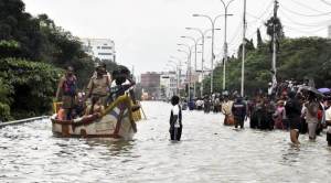 Chennai: People rescue from their Watter lodged houses during heavy rains in Chennai on Wednesday. PTI Photo (PTI12_2_2015_000351A)